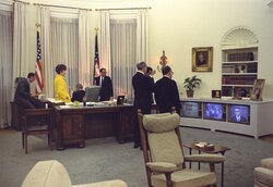 President Johnson and members of his staff watch TV news reports concerning the assassination of Martin Luther King Jr. on April 4, 1968