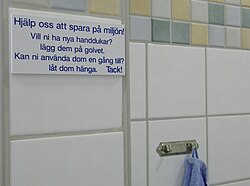 A sign on the wall of a Swedish hotel, using both the recommended[20] dem and the colloquial dom for the word "them" on the same sign.