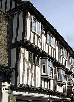 Projecting ("jettied") upper storeys of an English half-timbered village terraced house, the jetties plainly visible