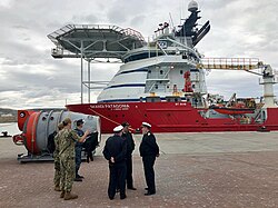 Argentine and US sailors in front of the Subsea Construction Support Vessel Skandi Patagonia