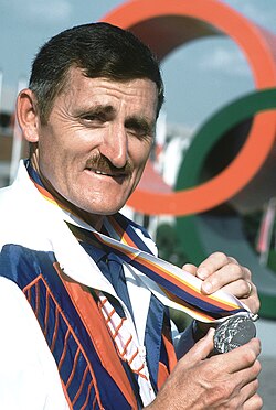 Erich Buljung shows a silver medal he won in the 10m air pistol competition at the 1988 Summer Olympics.