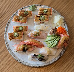 Some examples of Canadian sushi, including aburi oshizushi (炙り押し寿司), which was invented in Vancouver, and sushi donut.
