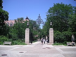 A large gate, with students walking through