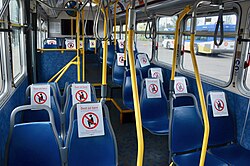 TriMet bus seats marked with signs encouraging social distancing during the COVID-19 pandemic.