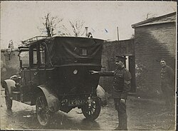 A sergeant pointing out the bullet hole resulting from the IRA ambush, December 1919