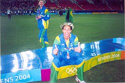 Brazilian footballer Aline Pellegrino seated on the Women's football tournament podium at the 2004 Summer Olympics