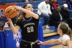A Privateers women's basketball game in 2024. Justice Ross holds the ball.