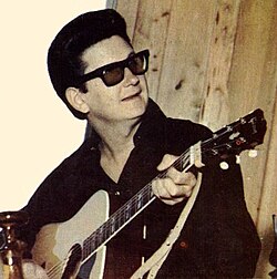 Orbison performing in his trademark dark glasses