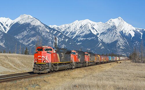 A Canadian National Railway freight train with three locomotives in the Canadian Rockies