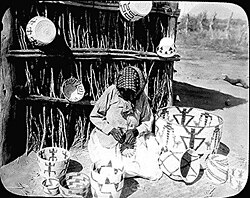 Tohono O'odham basket maker weaving, Arizona. Photograph by H. T. Cory, 1916.