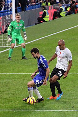 Fàbregas in action against Karl Henry of Queens Park Rangers in November 2014
