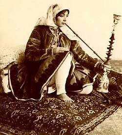 Iranian woman smoking traditional Qalyoon