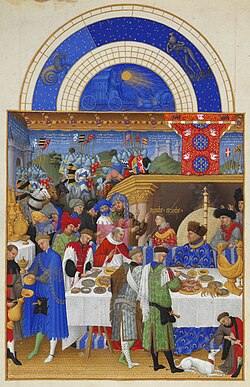 John, Duke of Berry enjoying a grand meal. The Duke is sitting with a cardinal at the high table, under a luxurious baldaquin, in front of the fireplace, tended to by several servants, including a carver. On the table to the left of the Duke is a golden salt cellar, or nef, in the shape of a ship; illustration from Très Riches Heures du Duc de Berry, circa 1410.