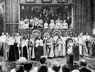 King George V and Queen Mary seated on the Chairs of Estate in front of the royal box at their coronation in 1911. It was the first time any part of the service had been photographed.