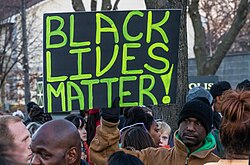 An activist holds a "Black Lives Matter" sign outside the Minneapolis Police Fourth Precinct building following the officer-involved killing of Jamar Clark on November 15, 2015