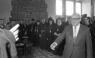 President Navon meeting with Christian leaders before Christmas and the christian New Year. In the background is an Israeli relief made of basalt ash.