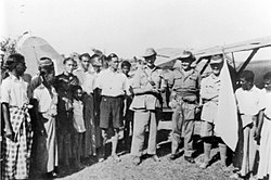 Australian officers with Rohingya men wearing typical lungis