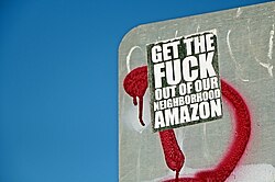 A sticker expressing an anti-Amazon message is pictured on the back of a street sign in Seattle