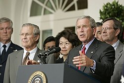 President Bush stands with Donald Rumsfeld, Elaine Chao, and Mike Leavitt during a press conference from the Rose Garden, regarding the devastation along the Gulf Coast caused by Katrina.