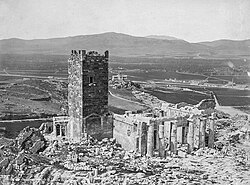 The Frankish Tower of the Acropolis of Athens in 1874, the year before it was demolished, with the ruins of the Propylaea and view west over the Athenian plain towards Mount Aigaleo