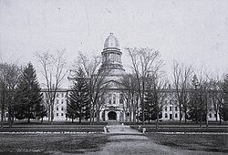 University Hall (center, 1872–1950), flanked by Mason Hall (left, 1841–1950) and South College (right, 1849–1950), was located partly on the grounds of present-day Angell Hall.