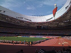 Inside Beijing National Stadium during the Games. Olympic cauldron in background.