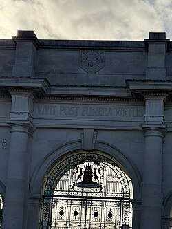 A large WWI memorial gate in Nottingham UK reading: "Virtue survives death" or "Virtue outlives death."[45]