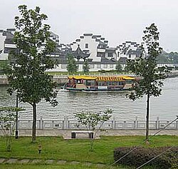 A boat on one of Shaoxing's waterways. North Zhejiang, known as the "Land of Fish and Rice", is characterized by its canals and waterways.