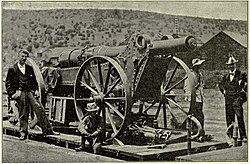 Boer Long Tom gun packed for travel on board a train with the barrel removed from the carriage.