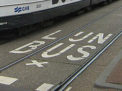 Dutch uses the digraph ⟨ij⟩ as a single letter and it can be seen in several variations. Here, a marking saying lijnbus ("line/route" + "bus"; the tram lane also serves as bus road).