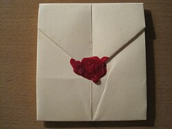 Hand-folded letter sealed with wax and stamped with capital letter "A". If a letter is folded and sealed correctly, a wax seal can eliminate the need for an envelope as demonstrated in the above picture.