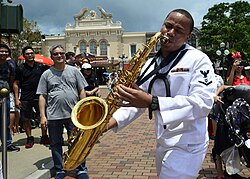 A US Seventh Fleet Band sailor with a tenor saxophone in Hong Kong