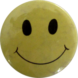 A badge bearing a smiley, a symbol of the 1980s acid house scene in the UK[92]