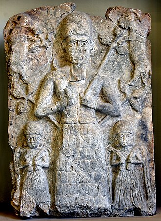 Wall relief from Assur, 2000–1500 BC, depicting a deity, probably Ashur, flanked by two water deities and two goats