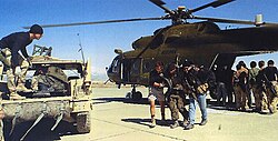 U.S. Special Forces helping Northern Alliance troops away from a CIA-operated MI-17 Hip helicopter at Bagram Airbase, 2002