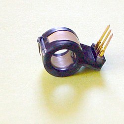 Hall effect current sensor with internal integrated circuit amplifier. 8 mm opening. Zero current output voltage is midway between the supply voltages that maintain a 4 to 8-volt differential. The non-zero current response is proportional to the voltage supplied and is linear to 60 amperes for this particular (25 A) device.