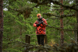 Hunter on a ground stand during a driven hunt in Finland