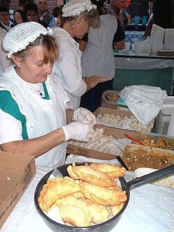 Argentine women making empanadas, a traditional Iberian food.