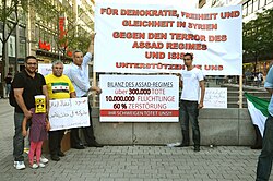 Members of the Syrian community in Hanover protest against Bashar al-Assad on the second anniversary of Ghouta chemical attacks, 21 August 2015.