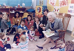 First Lady Barbara Bush, joined by Missouri governor John Ashcroft, with a "Parents as Teachers" group at the Greater St. Louis Ferguson-Florissant School District in October 1991. Mrs. Bush, who championed literacy as first lady, is reading Brown Bear, Brown Bear to the children.