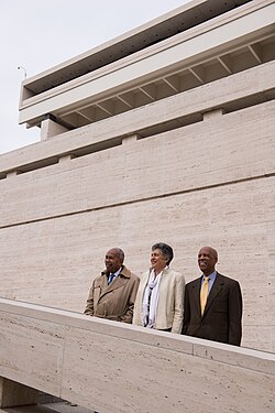 Three members of the "Little Rock Nine" (L-R) Ernest Green, Carlotta Walls LaNier, and Terrence Roberts – stand together on the steps of the LBJ Presidential Library in 2014