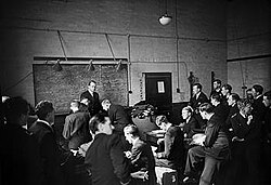 At a light coastal forces base, HMS Vernon, Operational Officer Lieutenant Commander Scott, briefs motor torpedo boat officers before they set off on anti-E-Boat patrols, June 1944
