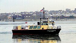 The survey vessel Linthicum in a channel near Fort McHenry; the ball-diamond-ball day shape displayed indicates a vessel restricted in its ability to maneuver.
