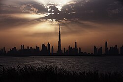 Photographic silhouette of the Downtown Dubai's skyline; Burj Khalifa, the world's tallest building, is visible at the center