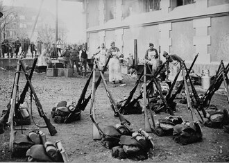 Swiss Army infantry kits arrayed in front of a field kitchen in Spitalacker, Bern during a workers' strike, c. 1918