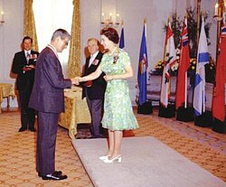 Elizabeth II, Queen of Canada and Sovereign of the Order of Canada, invests Jules Léger as a Companion of the order at Rideau Hall, August 1973.