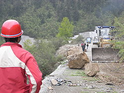 Persistent rain, as well as rock slides and a layer of mud coating on the main roads, such as the one above, hindered rescue officials' efforts to enter the target region.