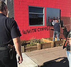 Clean up effort by the City of Denver at ink! Coffee in Five Points, Denver. The coffee shop was vandalized following the debut of a controversial ad campaign.