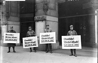 Nazi boycott of Jewish businesses, April 1933. The posters say "Germans! Defend yourselves! Don't buy from Jews!"