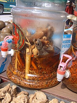 Ready to drink macerated medicinal liquor with goji berry, tokay gecko, and ginseng, for sale at a traditional medicine market in Xi'an, China